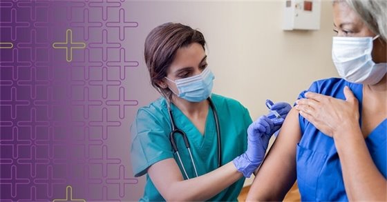 a woman wearing a mask getting a vaccine 